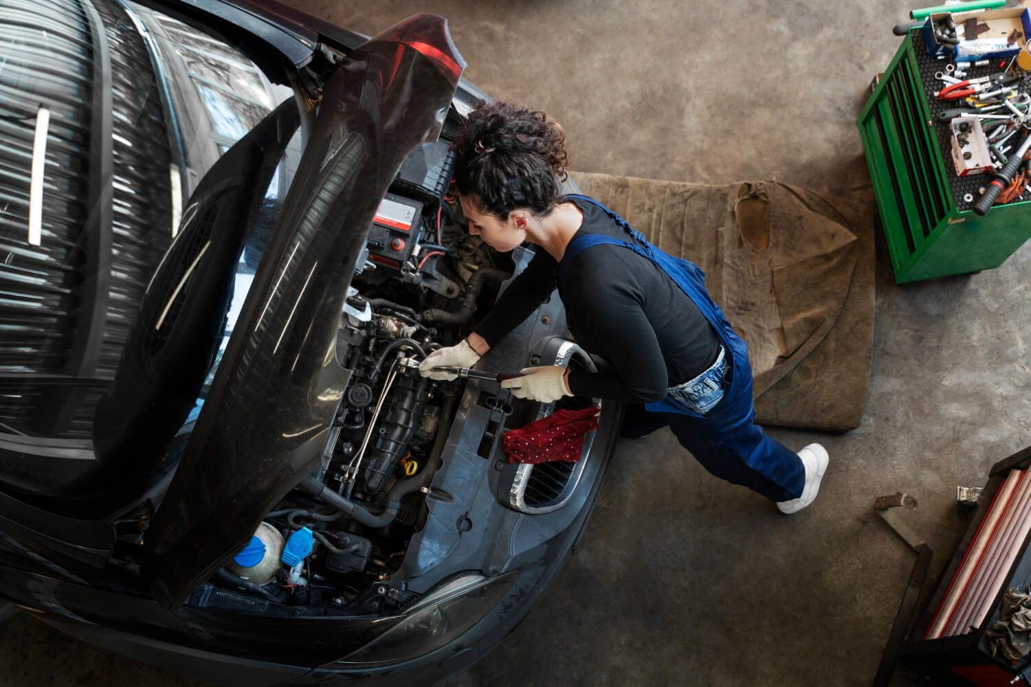 Mechanic working in an engine bay during timing belt service in Colonia NJ