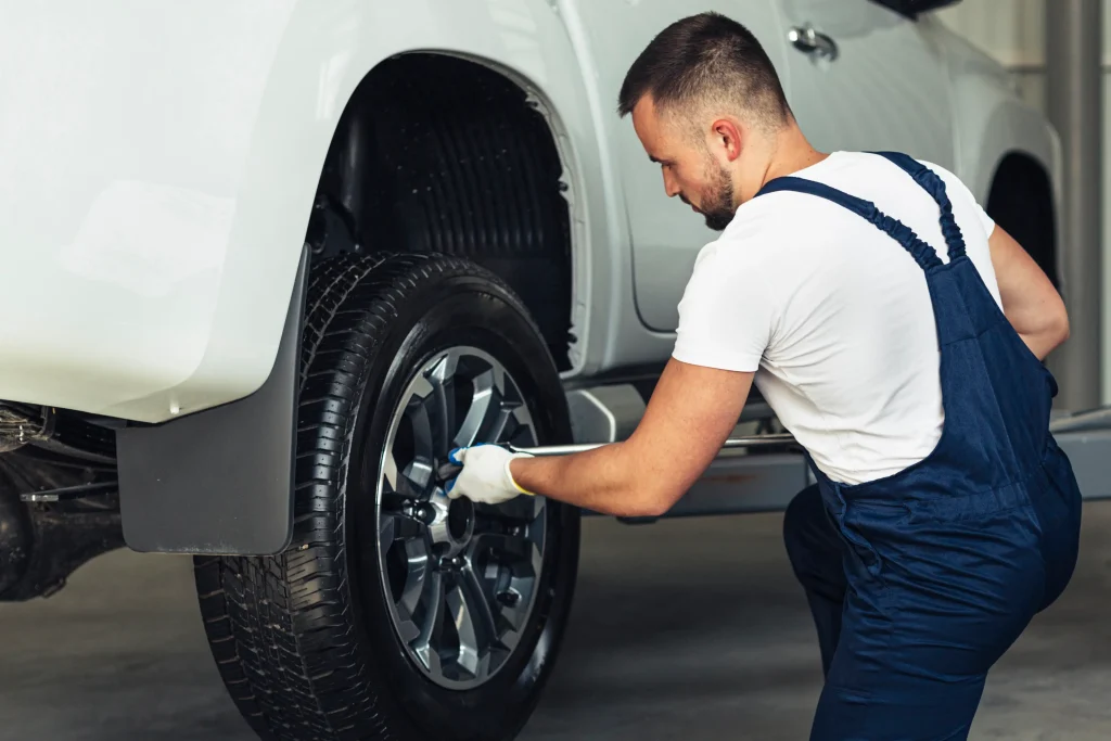 Technician tightening lug nuts after wheel balancing at American Auto Repair Center in Colonia NJ